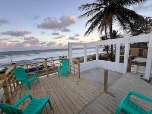 a deck with chairs and a view of the ocean at VSS Beach House - Arecibo in Arecibo