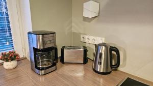 a blender and a coffee maker on a counter at Unique & Spacious 2 Bedroom Apartment with Sauna in Pärnu +5 photos