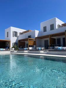 a swimming pool in front of a villa at CASA DI PIETRA MYKONOS in Klouvas