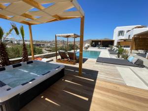a hot tub on the deck of a house at CASA DI PIETRA MYKONOS in Klouvas