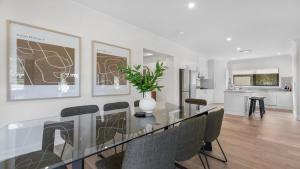 a dining room with a glass table and chairs at Greenview in Pokolbin +16 photos