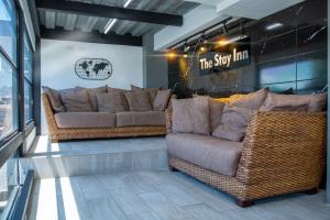 a store with two couches and a sign on the wall at The Stay San Jose in San José