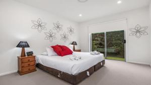 a bedroom with a large bed and a window at Dashaz Dream - The Vintage in Pokolbin