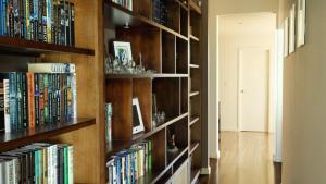 a library with wooden shelves filled with books at Dashaz Dream - The Vintage in Pokolbin +6 photos