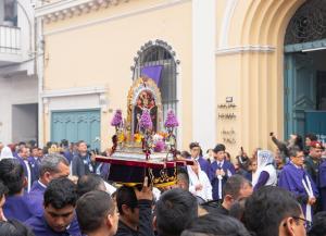 a group of people holding up a small shrine at Residencial Roma Bed & Breakfast in Lima