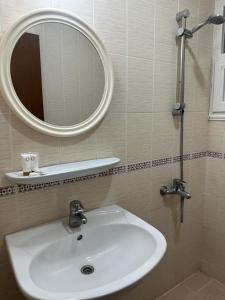 a bathroom with a sink and a mirror at Pyramiza Fahaheel in Kuwait