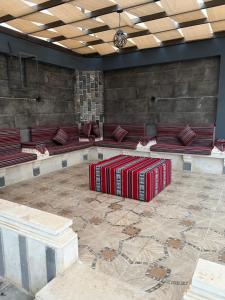 a room with red seats and a table with luggage at Dahab villa in Al Rama