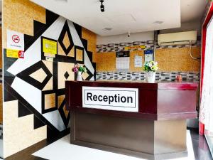 a reception counter in a restaurant with a sign on the wall at ARK HOTEL SUBANG in Shah Alam
