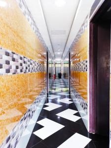 a hallway with a black and white checkered floor at ARK HOTEL SUBANG in Shah Alam