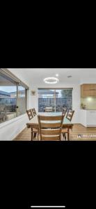 a dining room with a table and some chairs at Home away from Home 22 mins from Airport and CBD in Truganina