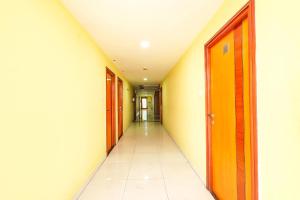 an empty corridor in an office building with a hallway at FabHotel Prime Mahalaya Residency in Chennai