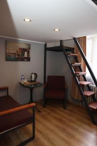 a room with a staircase and a table and a chair at The Time Hotel Adana in Seyhan