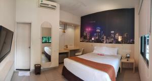 a hotel room with a bed and a view of a city at D'Bamboo Suites in Jakarta