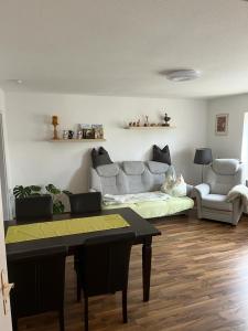 a living room with a couch and a table at Pension Rudolph Riesa in Riesa