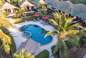an aerial view of a resort swimming pool with palm trees at Phatcharee Resort in Baan Tai