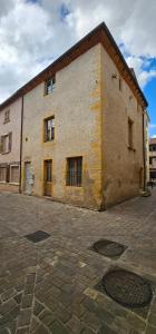 a large brick building with windows on the side of it at Le Petit Grenette in Charlieu