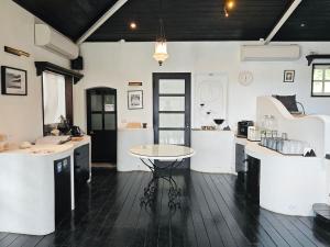 a kitchen with white counters and a table at 金石新月光 in Jiufen