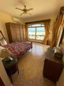 1 dormitorio con cama y vistas al océano en فيلا دوبلكس مع حديقة وشواية en El Tor
