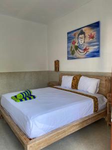 a bedroom with a large bed in a room at COCONUT BEACH BUNGALOWs & WARUNG in Amed