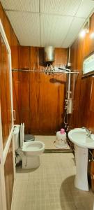 a bathroom with a toilet and a sink at Sampala Resort in Masinagudi