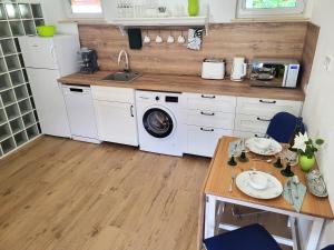 a kitchen with a sink and a washing machine at Villa Agardy 1 in Balatonkenese