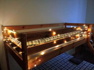 a wooden bunk bed with lights on it at Green Park Rooms Brno in Brno +45 photos