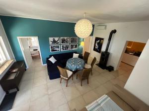 a living room with a couch and a table and chairs at Villa Rapunzel in Brovinje +15 photos