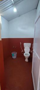 a bathroom with a toilet and a bidet at Sampala Resort in Masinagudi