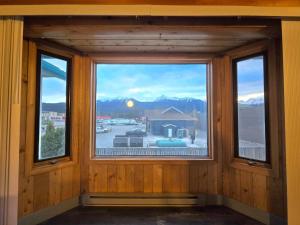 a window in a room with a view of the mountains at Alpine Inn in Valemount