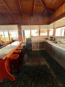 a kitchen with a counter and stools in it at Volcano Views Glampings & Crystal House in Monterrey