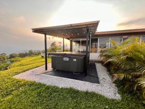 a gazebo in the yard of a house at Volcano Views Glampings & Crystal House in Monterrey