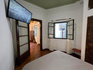 a bedroom with a bed and a window at Historic apartment in the city in Buenos Aires