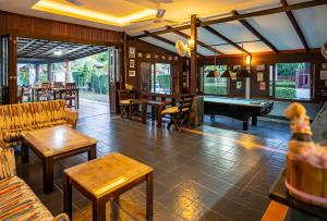 a living room with couches and a pool table at Phatcharee Resort in Ban Tai