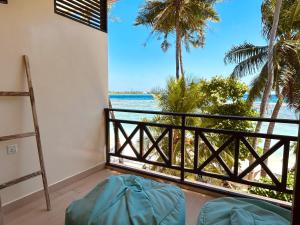 a room with a balcony with a view of the ocean at Canopus Retreat Thulusdhoo in Thulusdhoo