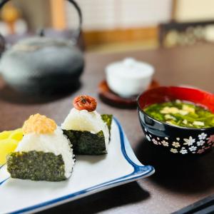 two pieces of sushi on a plate next to a bowl of soup at 湖北 寺の宿- GuestHouse去-来-現Ko-Rai-Gen in Nagahama