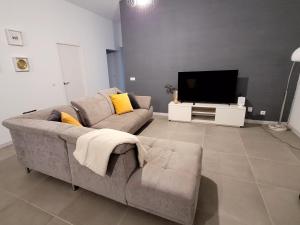 sala de estar con sofá y TV en La Kasita en Arafo