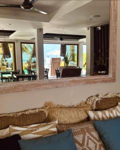 a mirror above a couch in a living room at Canopus Retreat Thulusdhoo in Thulusdhoo