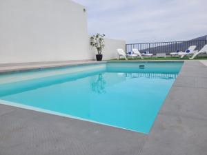a swimming pool with blue water in a building at La Kasita in Arafo