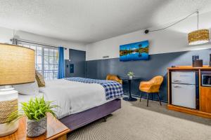 a bedroom with a bed and a desk at The Angler Lodge in Dunsmuir