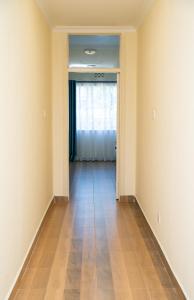an empty room with a hallway with a window at Kongoni House in Nairobi