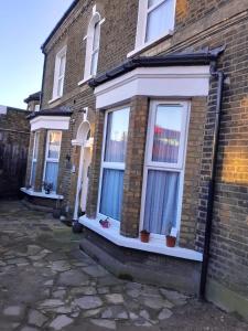 a brick house with windows on the side of it at Place to stay in Longbridge in Barking