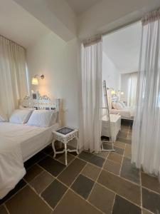 sypialnia z 2 łóżkami i dużym oknem w obiekcie Oceanic - Luxury Boutique Hotel w mieście Palolem