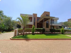 a house with a lawn in front of it at Palm House in Nairobi