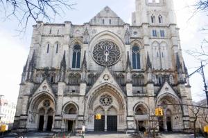 a large cathedral with a clock on the front of it at Spacious 4 Bedroom Apartment in New York
