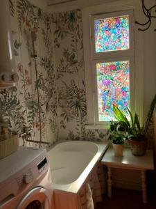 a bathroom with a tub and a stained glass window at Romantic Seaside House in Pärnu