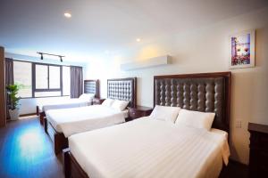 Postel nebo postele na pokoji v ubytování River Park Hotel Dalat