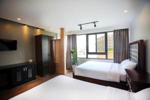 Postel nebo postele na pokoji v ubytování River Park Hotel Dalat