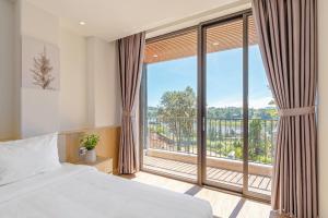 Postel nebo postele na pokoji v ubytování River Park Hotel Dalat