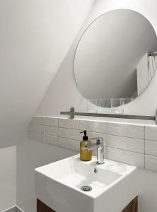 a bathroom with a sink and a mirror at Nussbaum Panzió in Keszthely