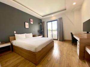 Postel nebo postele na pokoji v ubytování River Park Hotel Dalat
